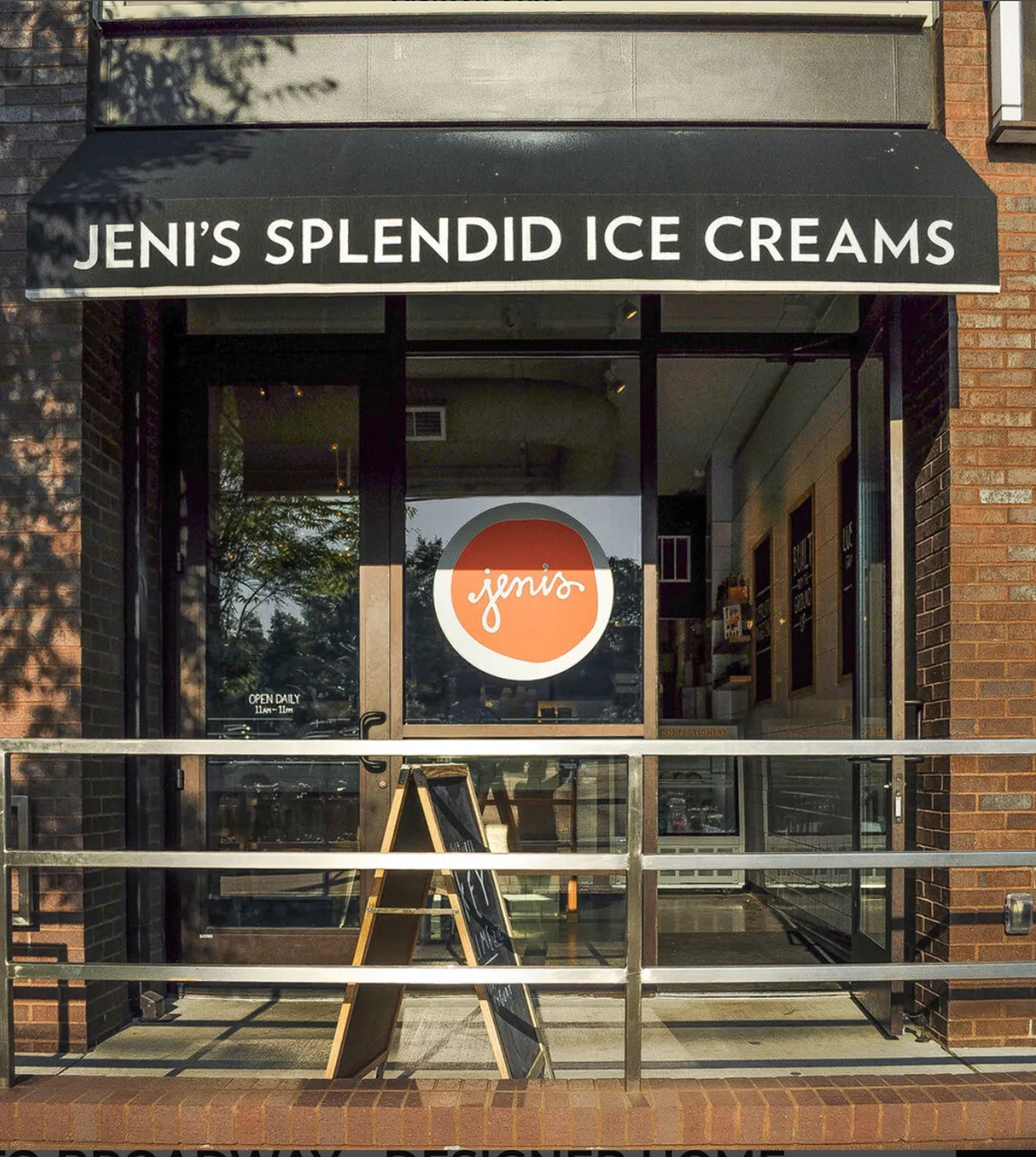 A cheerful ice cream shop with a welcoming storefront, visible sign, and glass entrance. The scene is lively, suggesting opportunities for shared treats, fun date stops, or commemorating a special occasion during a romantic stroll.